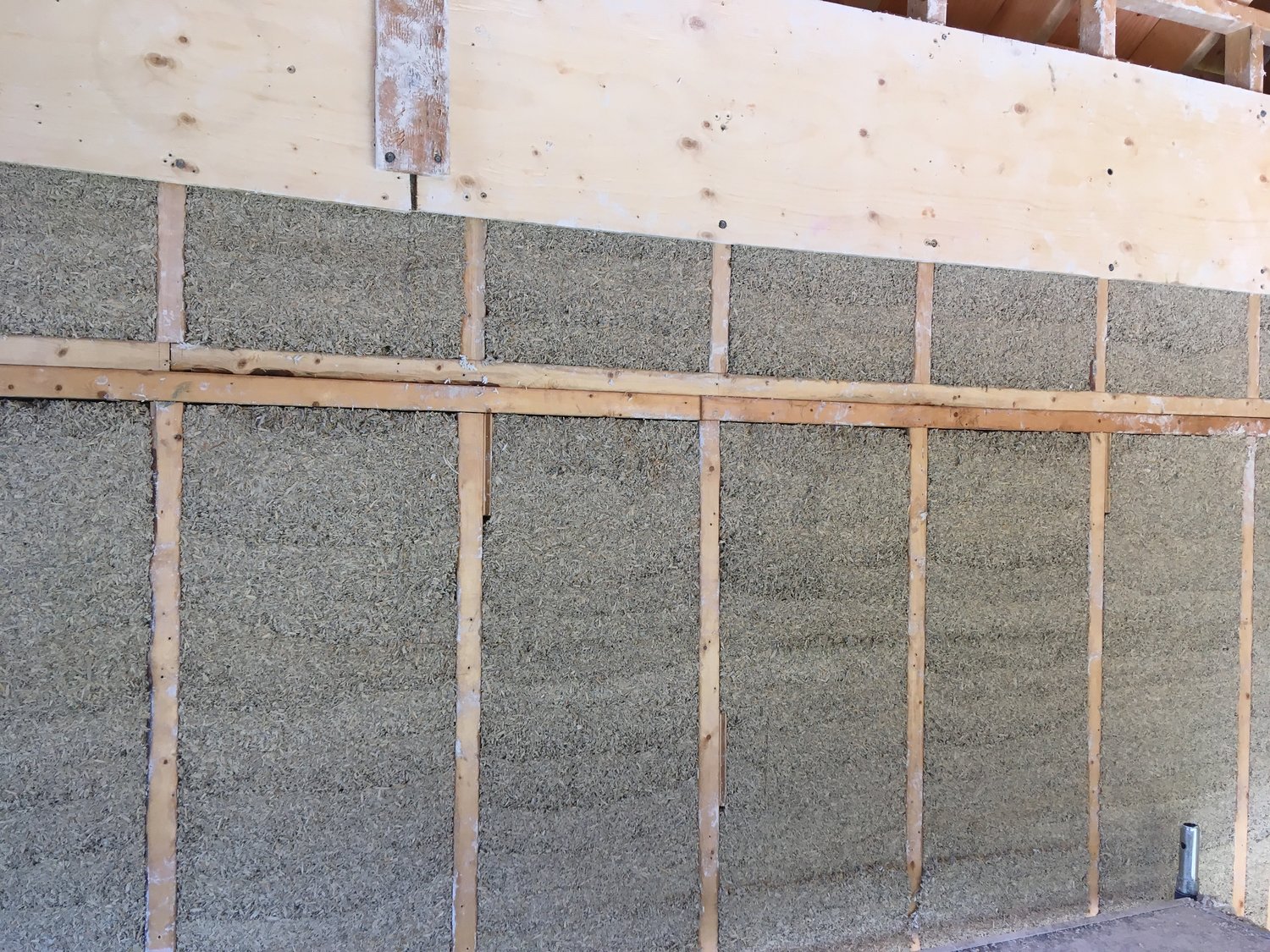 Cellulose insulation is a type of wood- or paper-based product. It is mechanically blown into or onto empty spaces in the structural part of a house to slow down the transmission of heat or cold. Because of the nature of the loose material,  it can fit in enclosed areas (such as walls, pictured here) and can conform around obstructions such as wires and ducts (found both in walls and in attics).